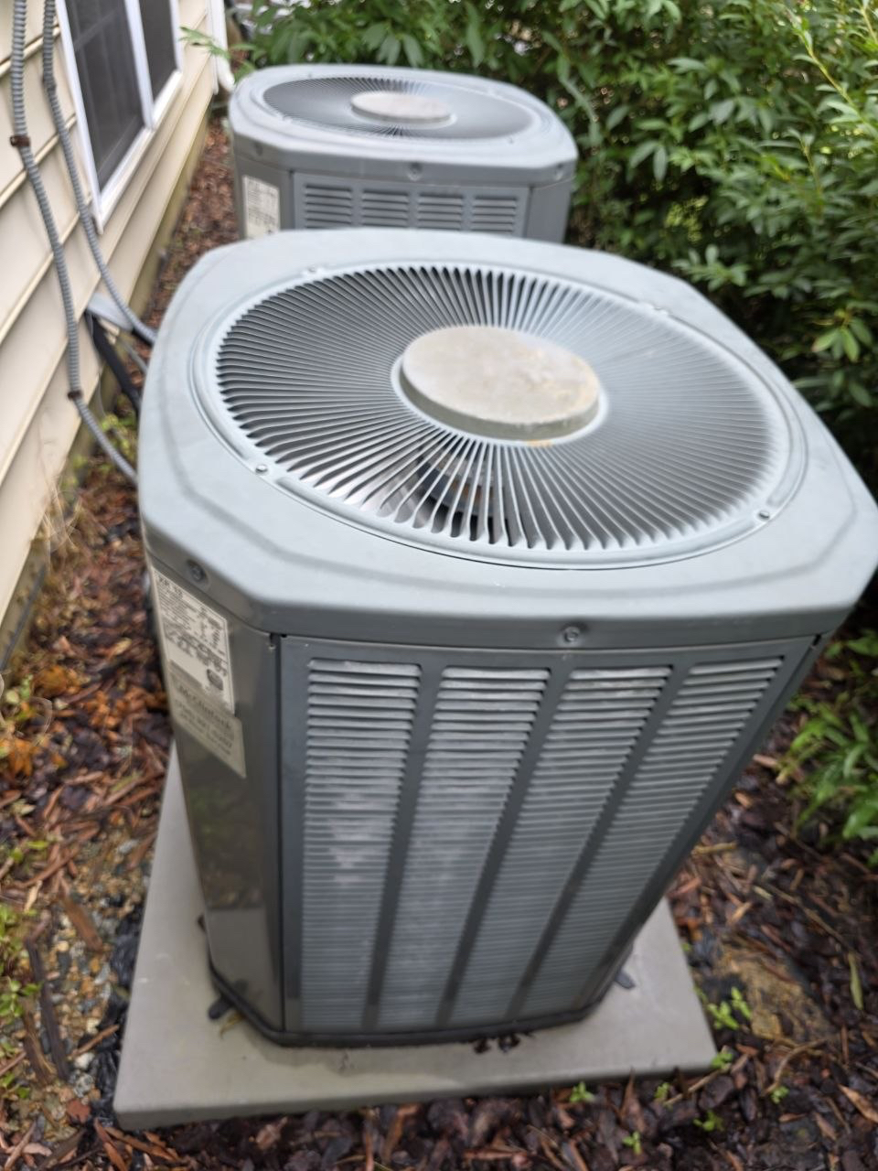 Outdoor AC condensers beside a home